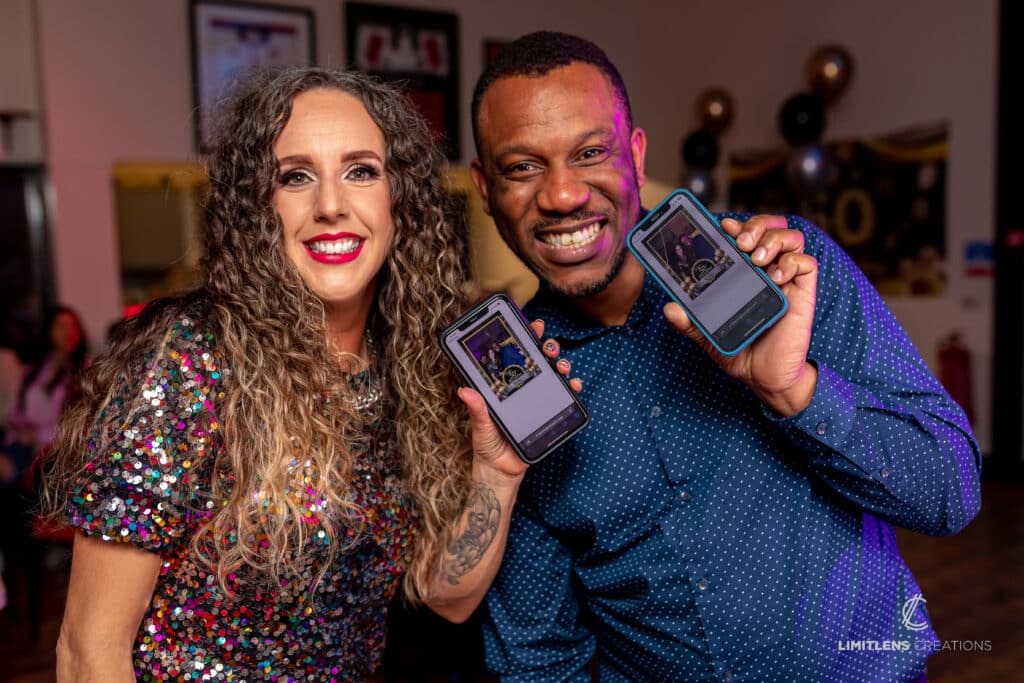 Guests smiling with printed photo booth strips.